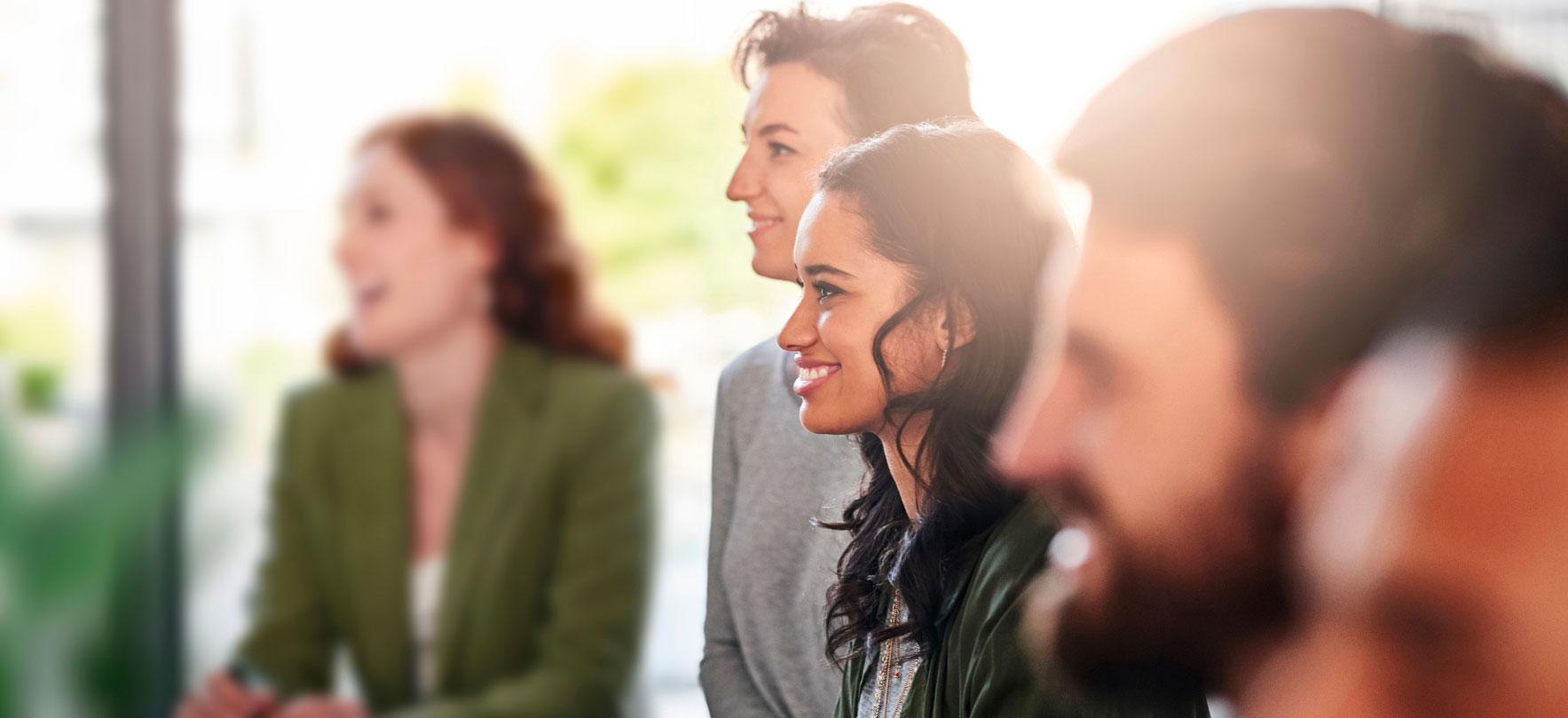 Group of young professionals attentively listening in a bright, modern setting